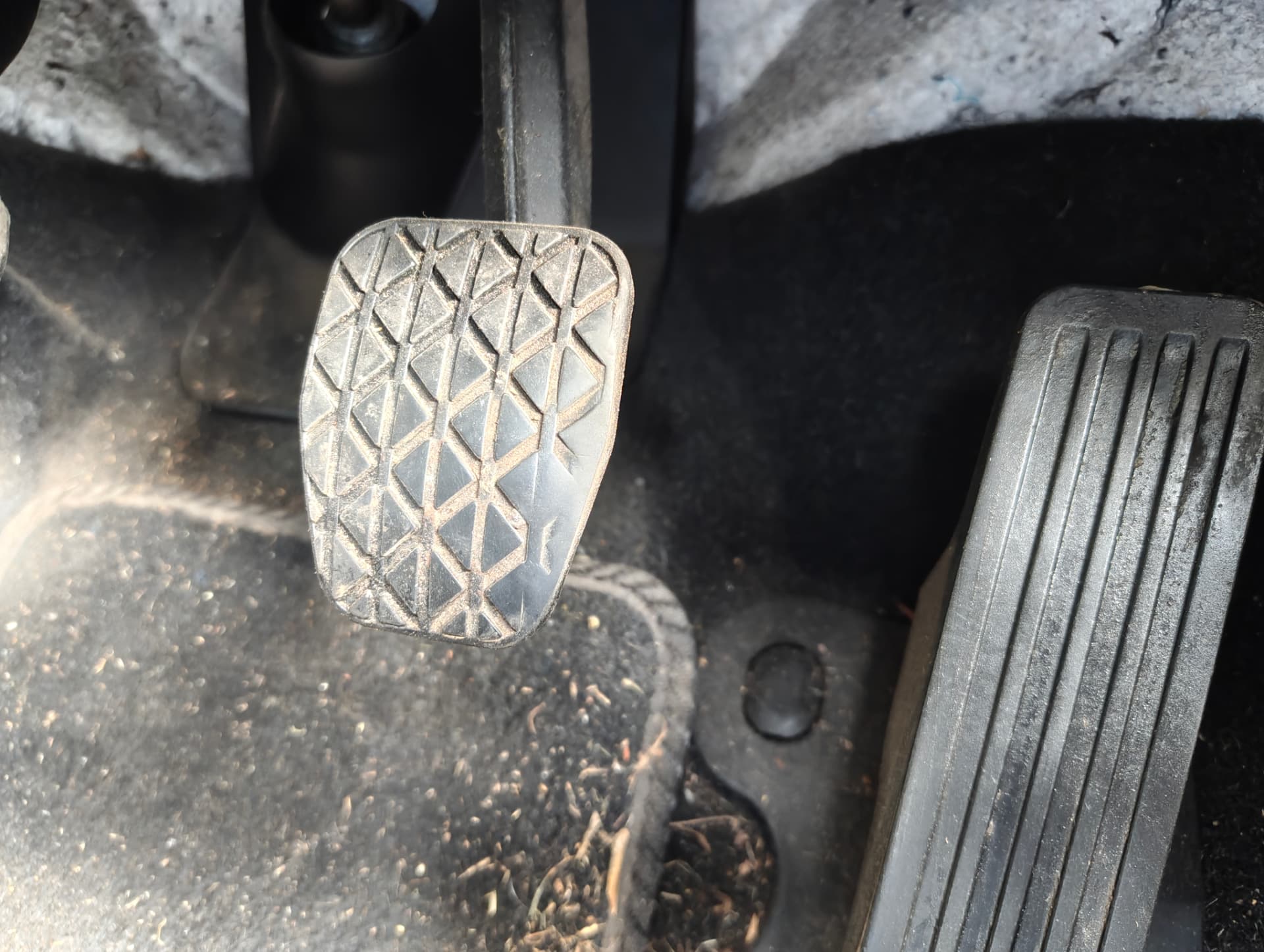 Pedal area and carpet before deep cleaning