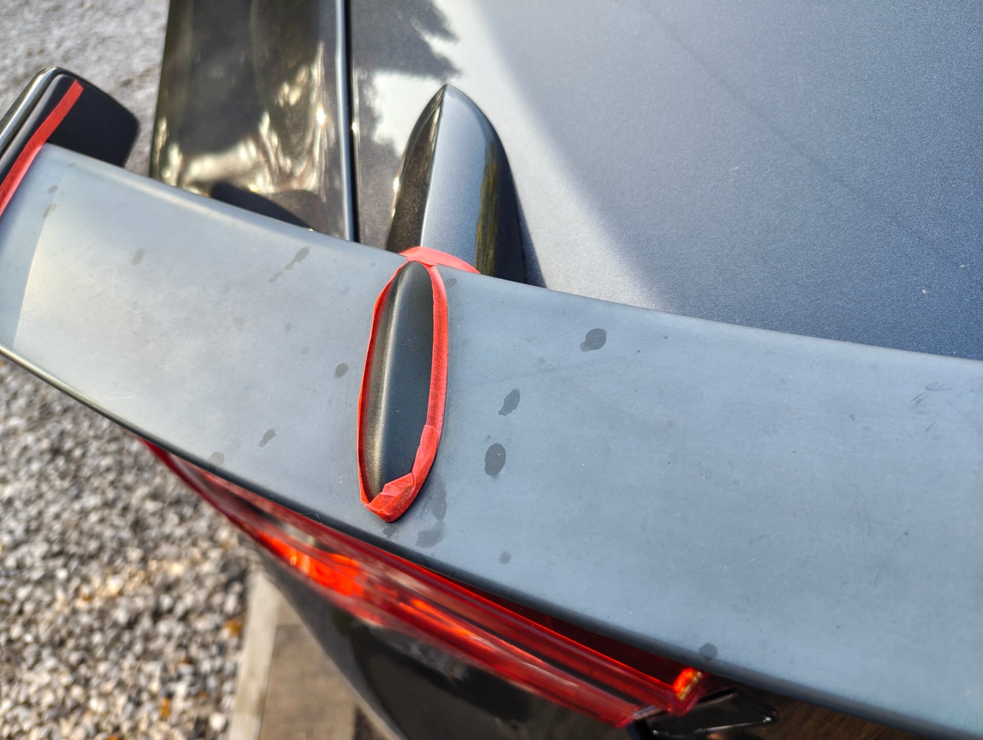 GT86 spoiler masked off with tape for machine polishing