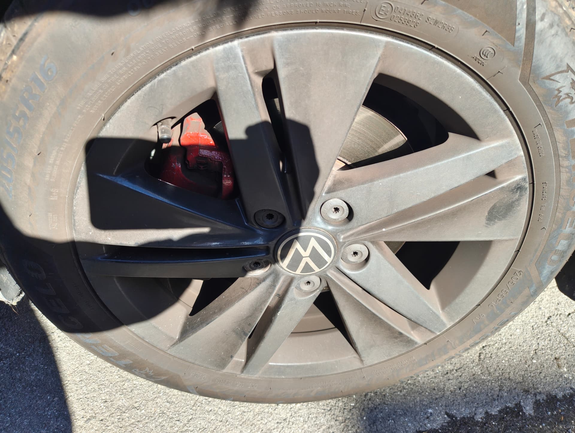 Golf alloy wheel coated in thick brake dust before cleaning