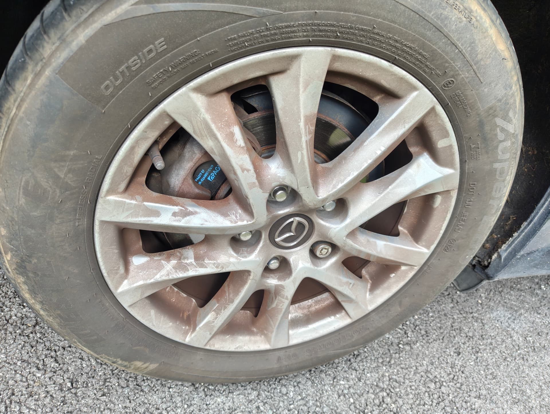 Alloy wheel covered in brake dust before decontamination