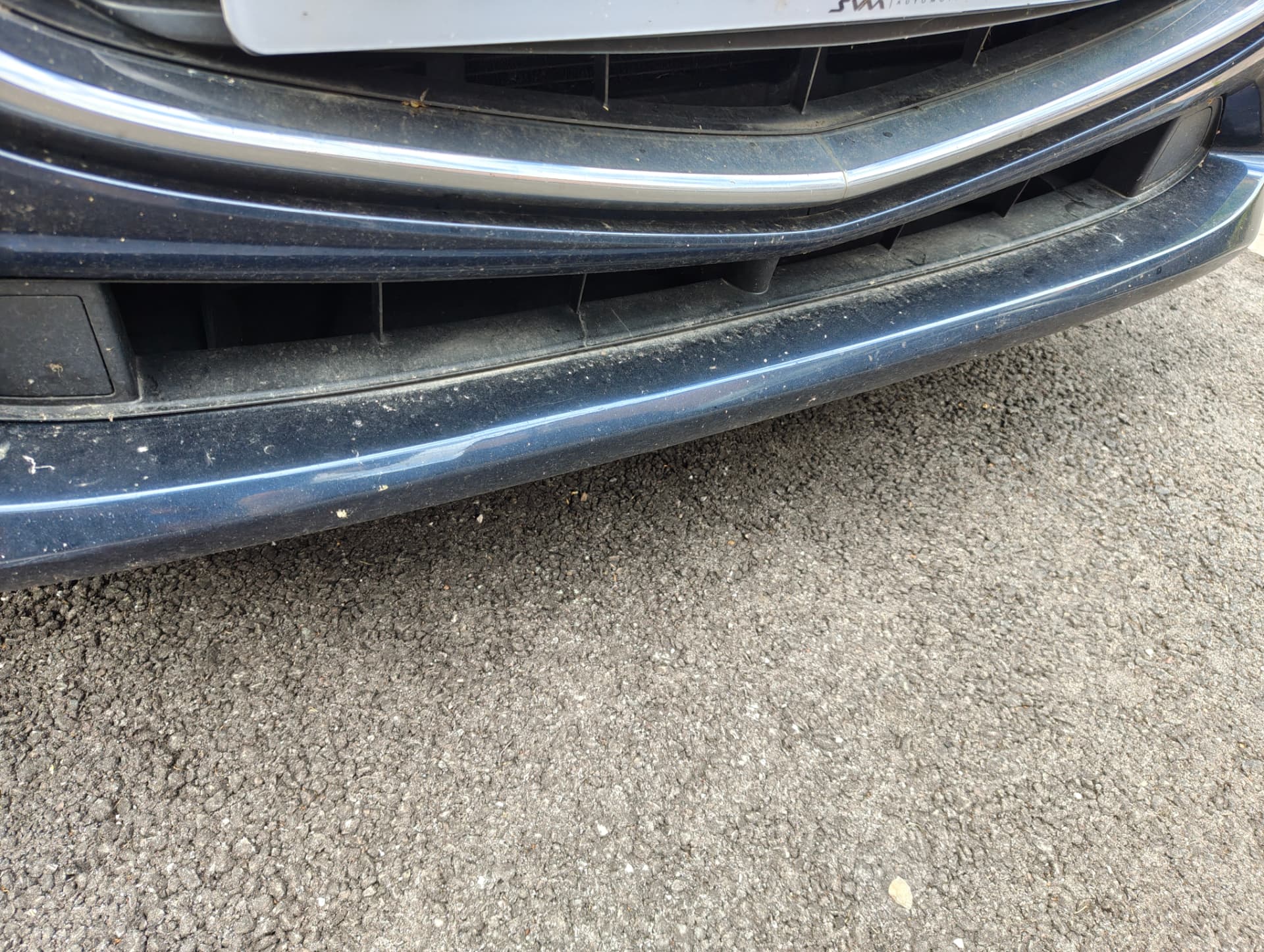 Front bumper with road grime before wash