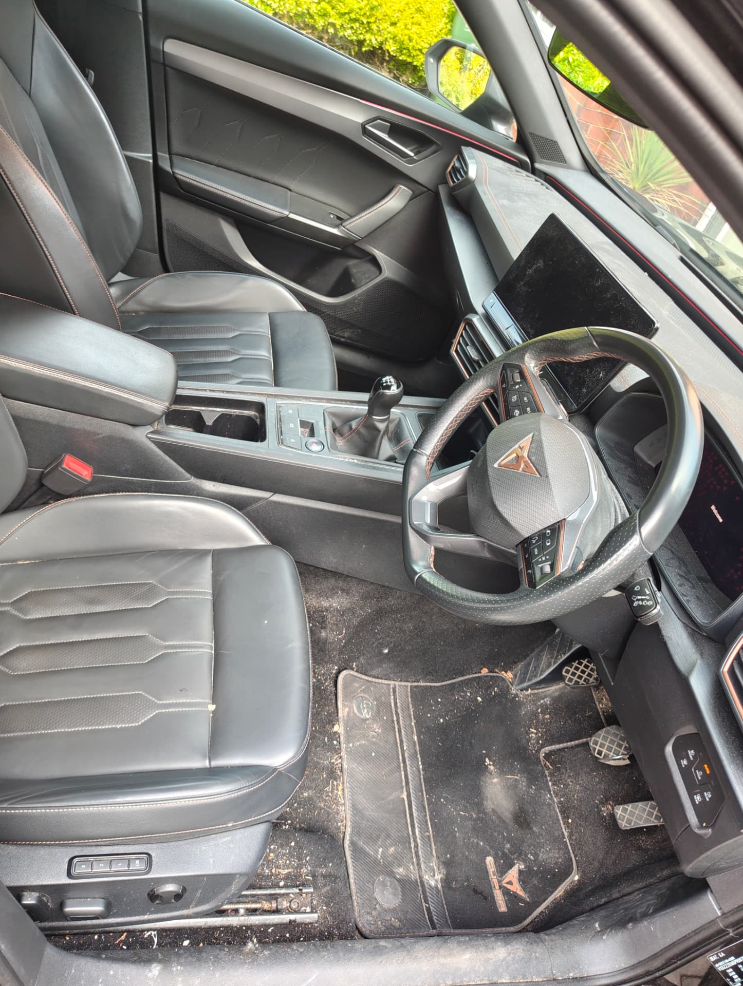 Cupra interior with dirty floor mats and seats before deep clean
