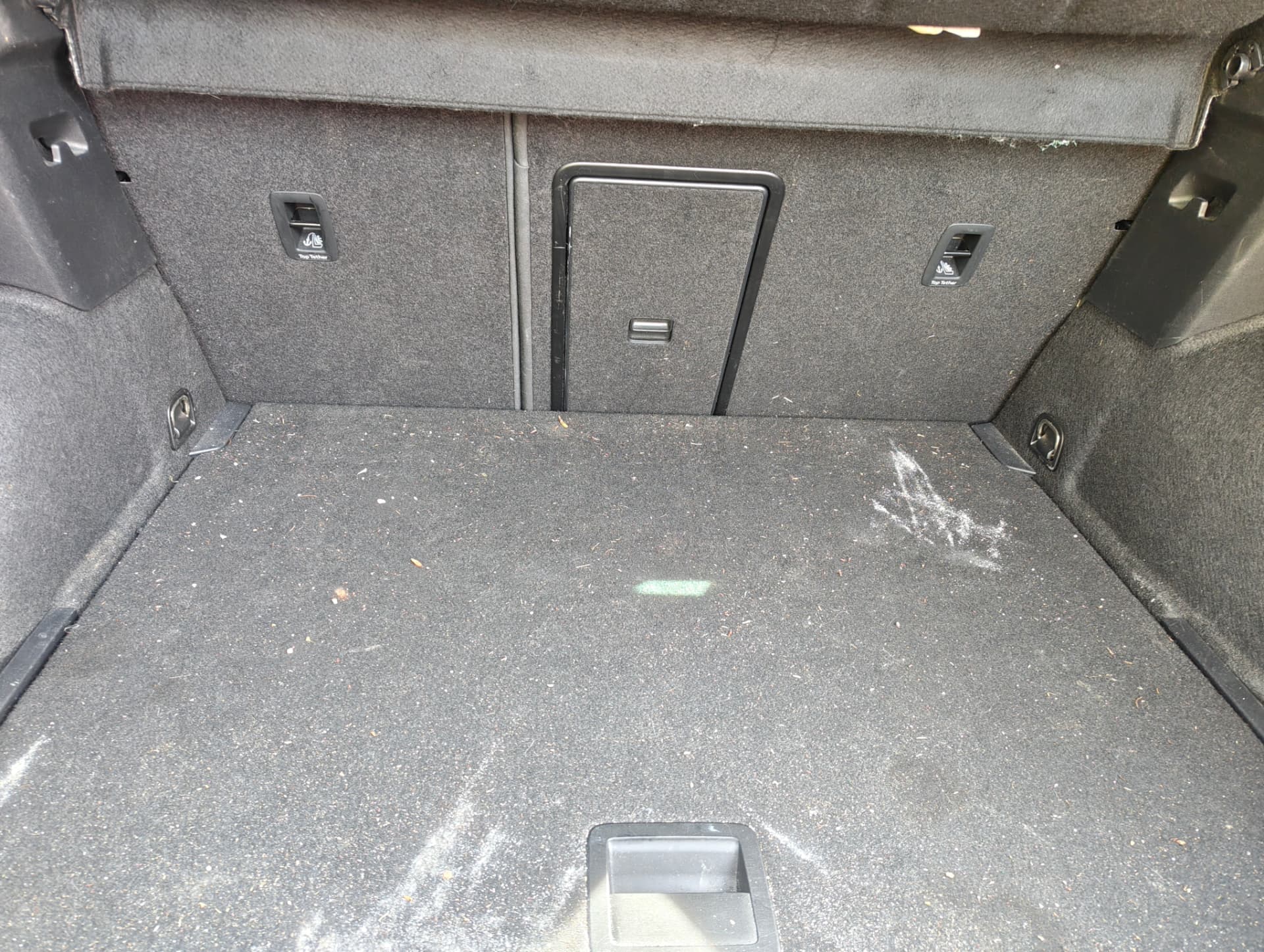 Cupra boot carpet with debris before extraction