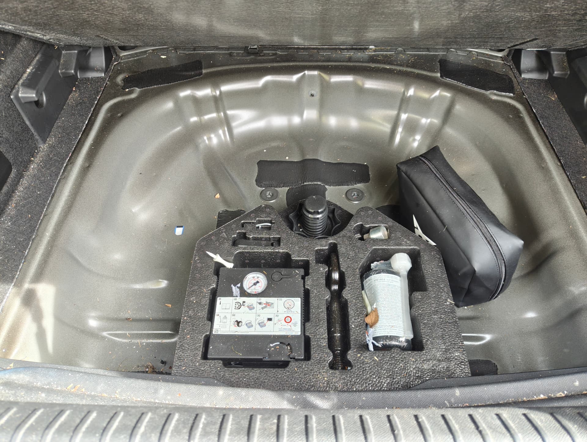 Cupra boot well with trim and tools before cleaning